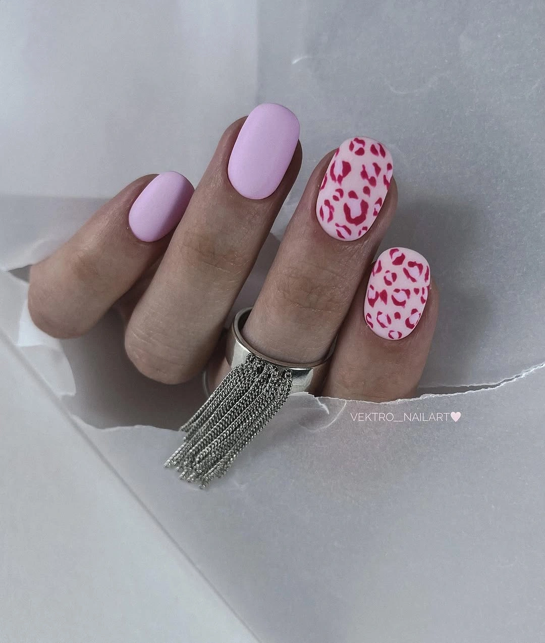 pastel lavender square nails with one bright pink spotted accent