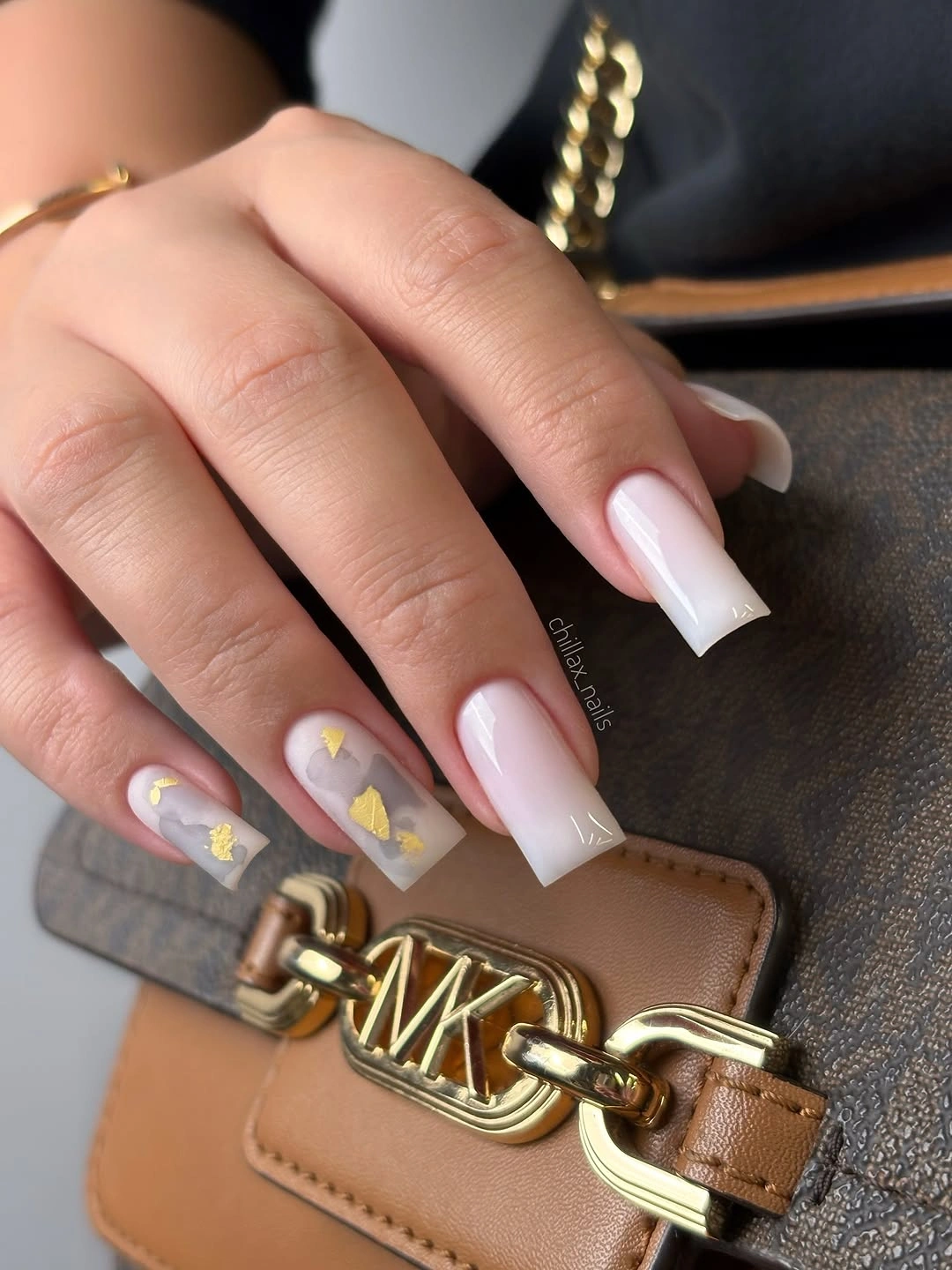 blush square nails with white French tips and tiny yellow accents