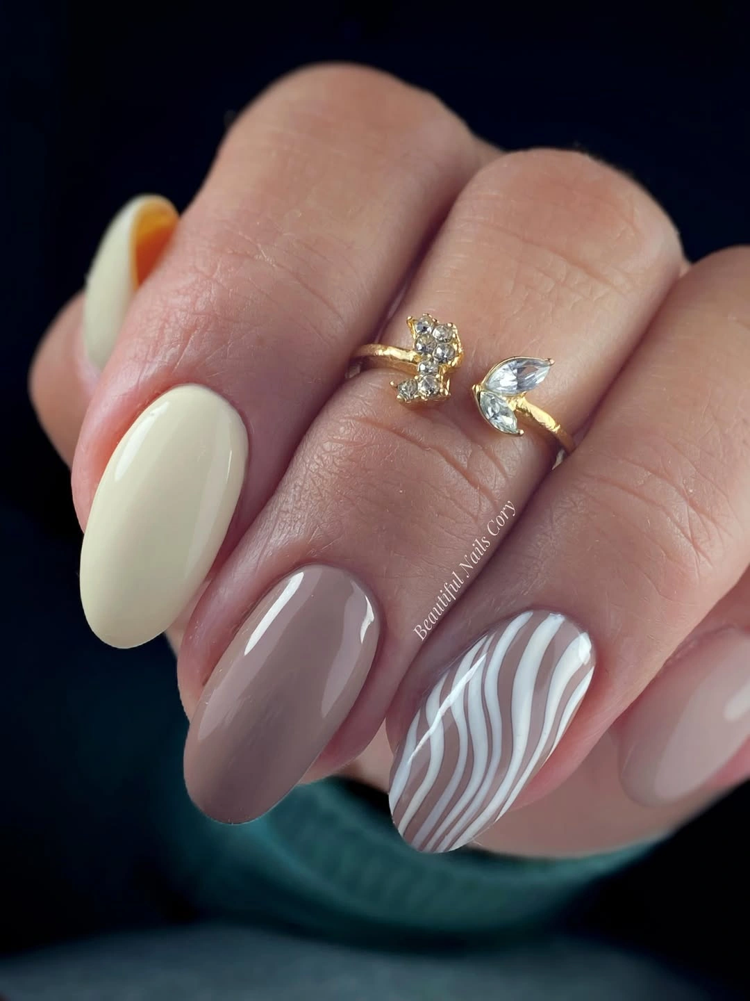 Medium almond taupe and ivory nails with a white wave accent