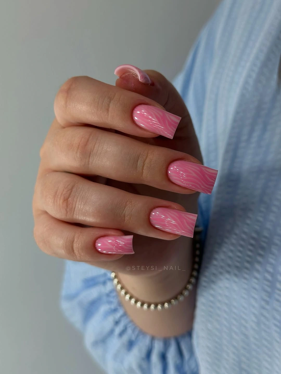 Long square glossy pink nails with fine pale texture lines