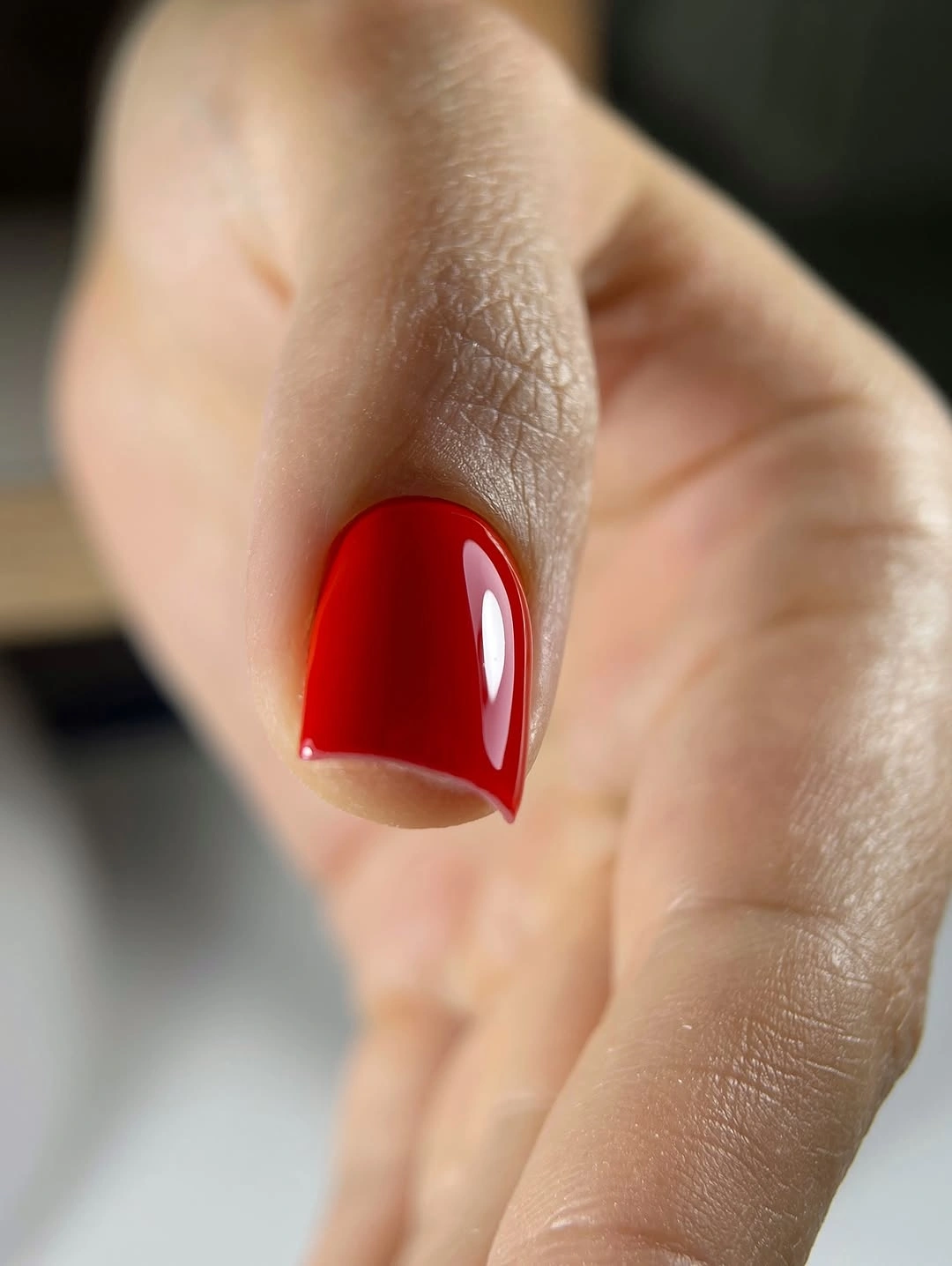 Short rounded square nails in glossy cherry red polish