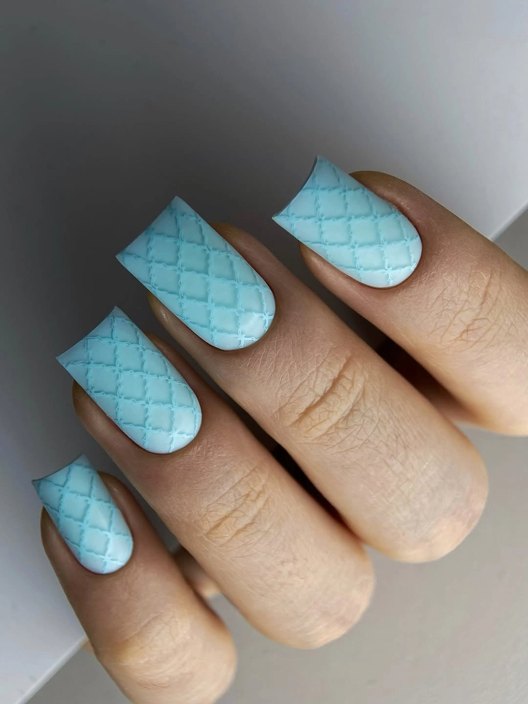 Medium square pastel blue nails with a quilted diamond pattern