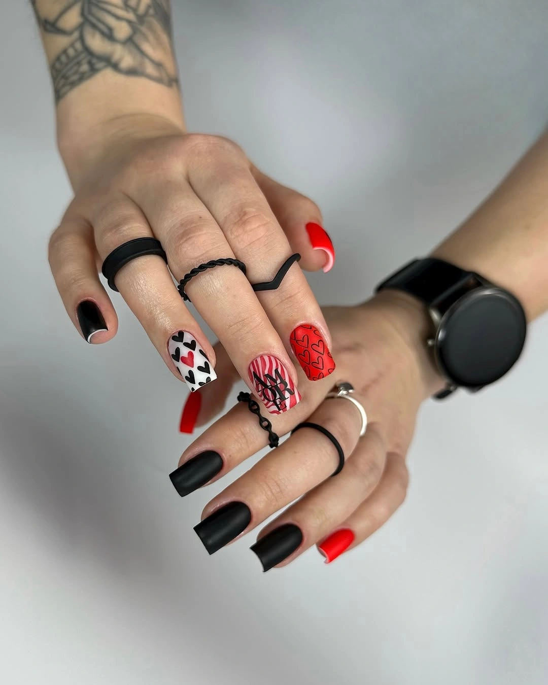 Short square nails with black red checkerboard and pink graphics