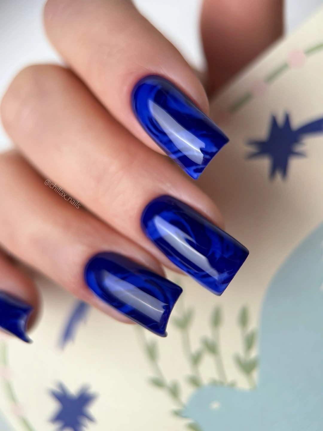 Long square nails in electric blue with glassy reflection