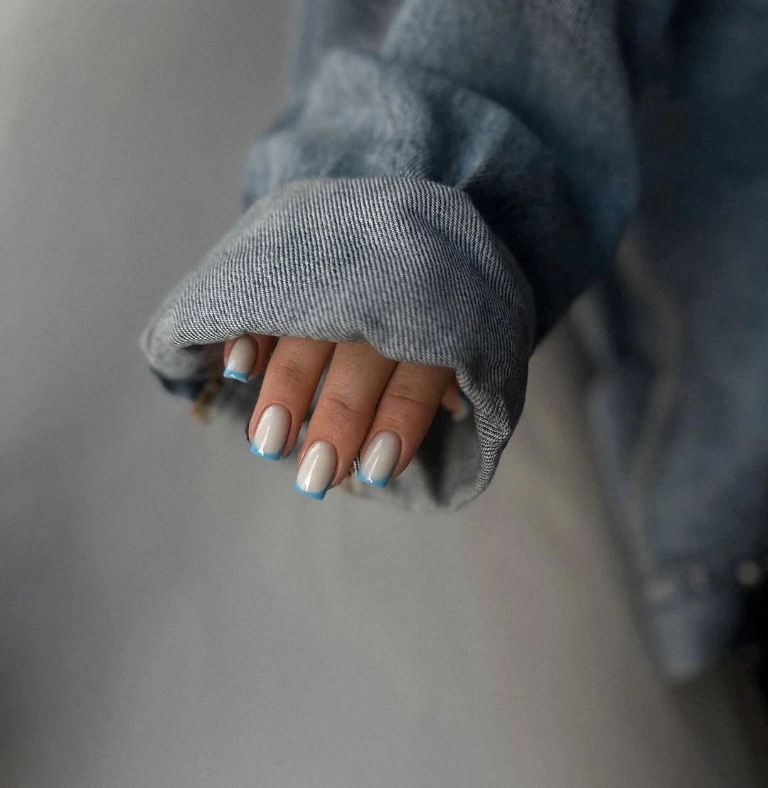 Short white square nails with pale blue French edges