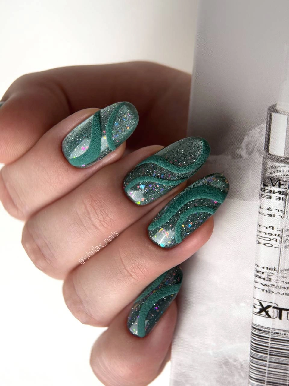 Long square teal nails with glitter and dark curved details
