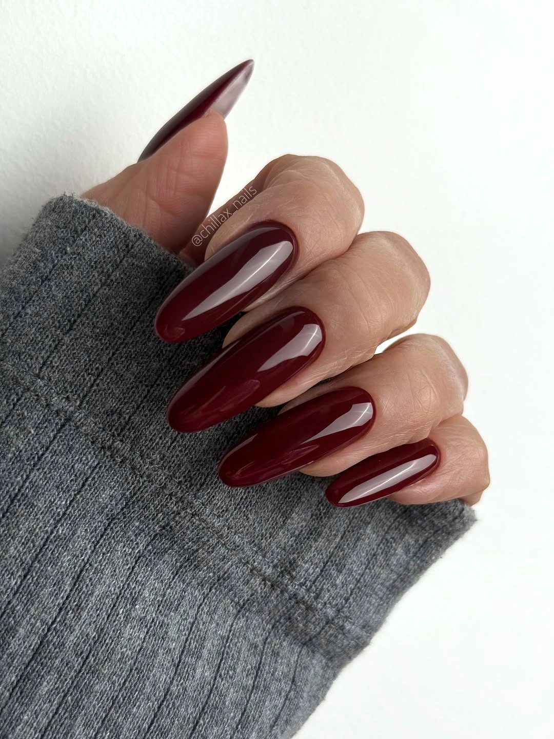 Long stiletto nails in deep glossy burgundy