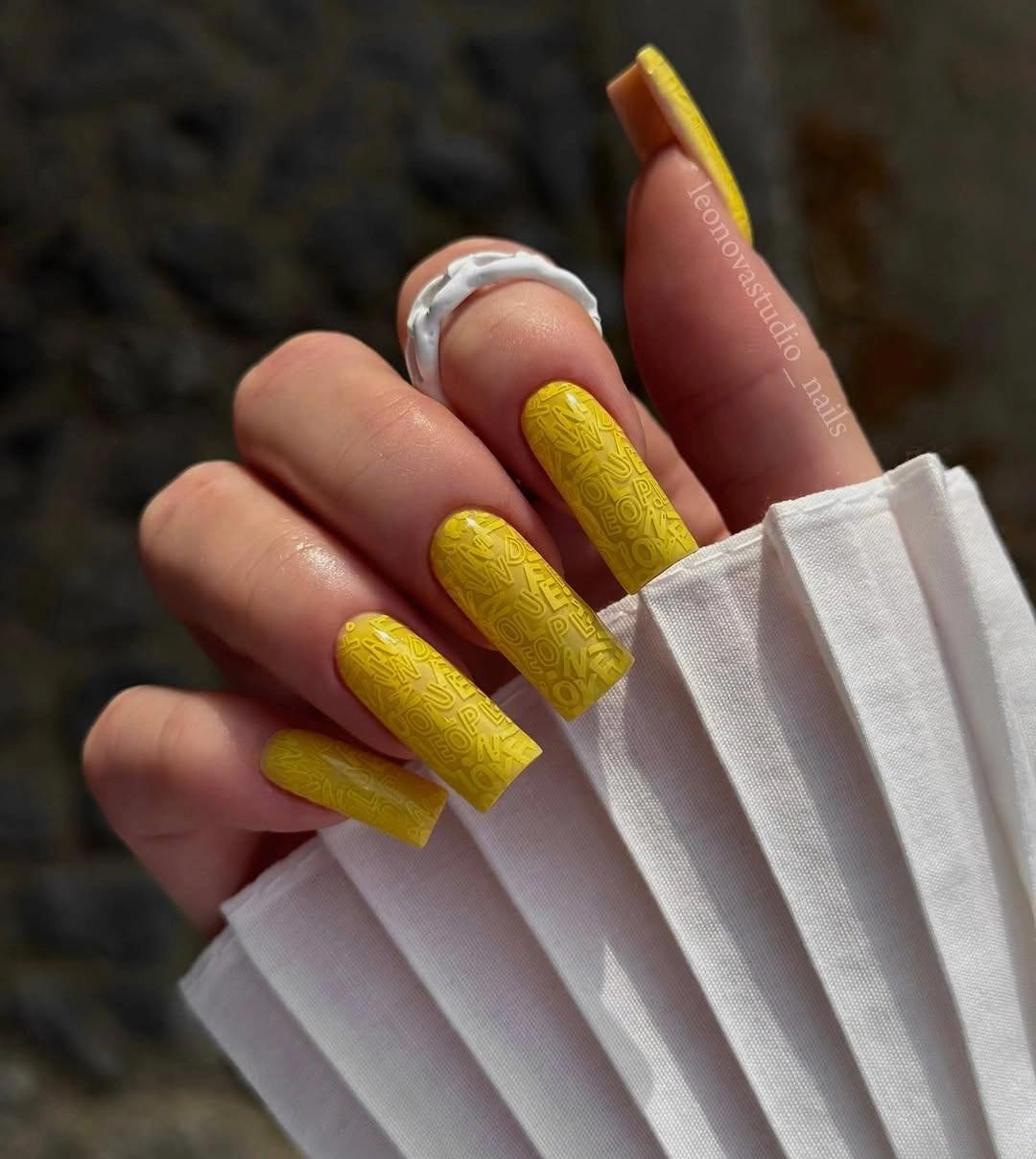 Long yellow square nails with subtle tonal surface texture