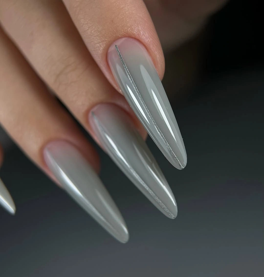 Long translucent gray white stiletto nails with glassy shine