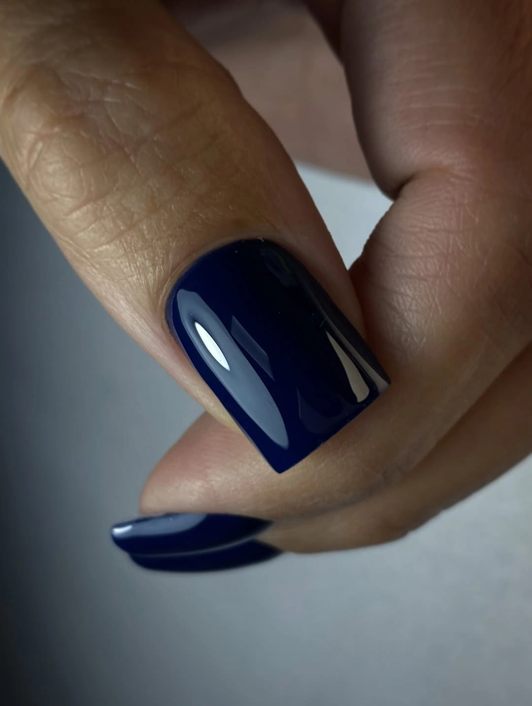 Short square nails in glossy saturated deep navy blue