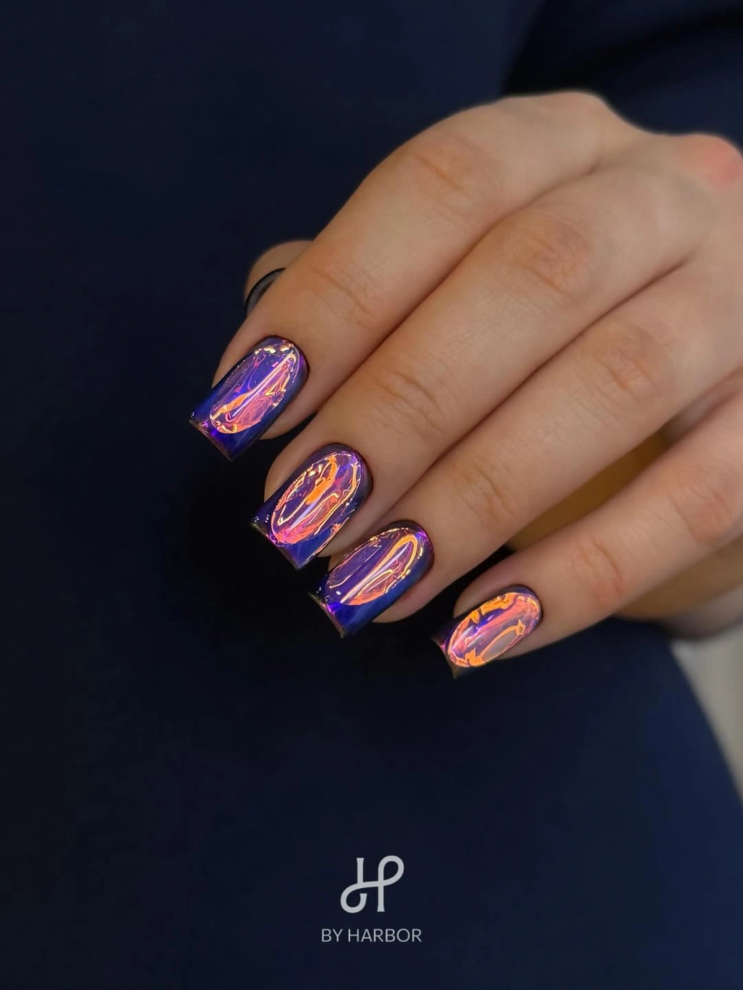Short square nails with vivid blue purple abstract reflective swirls