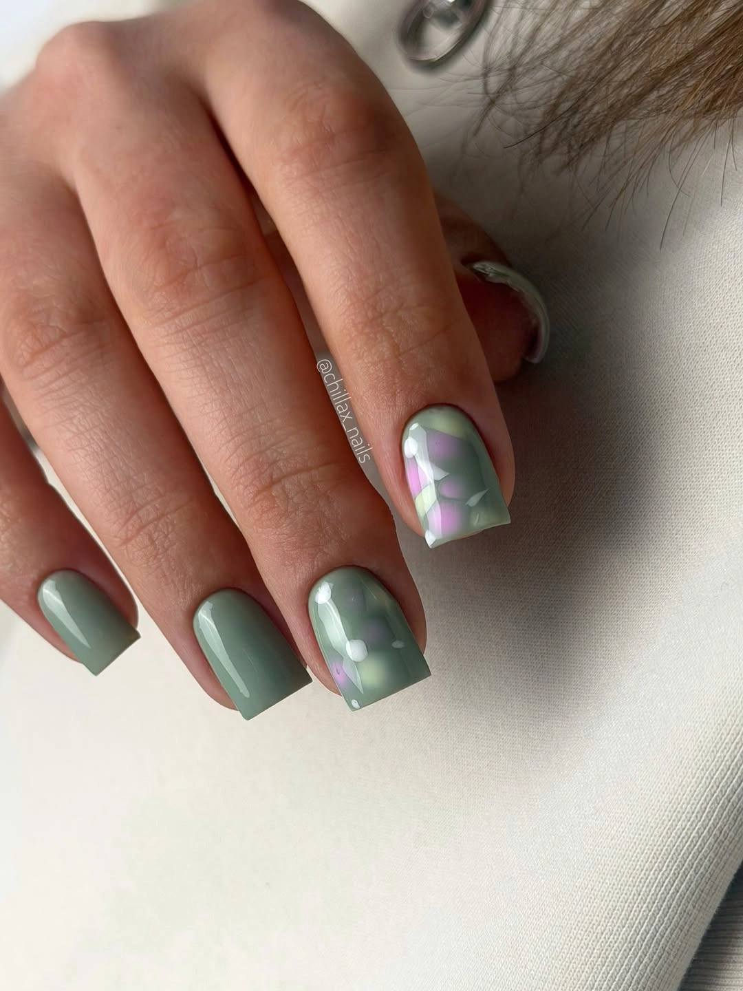 Short sage square nails with pale iridescent bubble accents