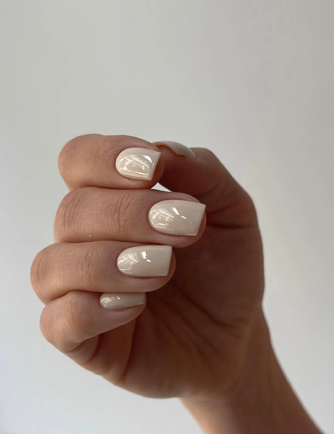 Short square nails in a softly milky white polished finish