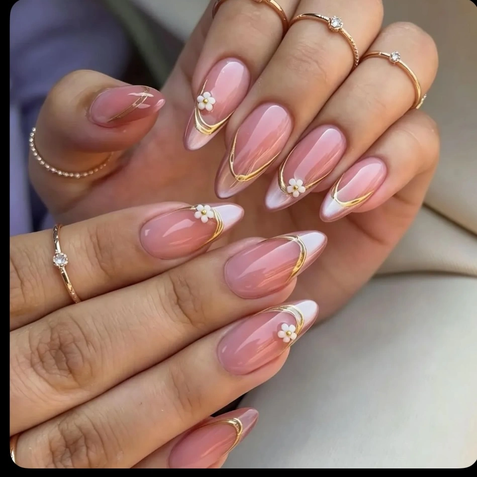 Blush almond nails with gold arcs and daisies