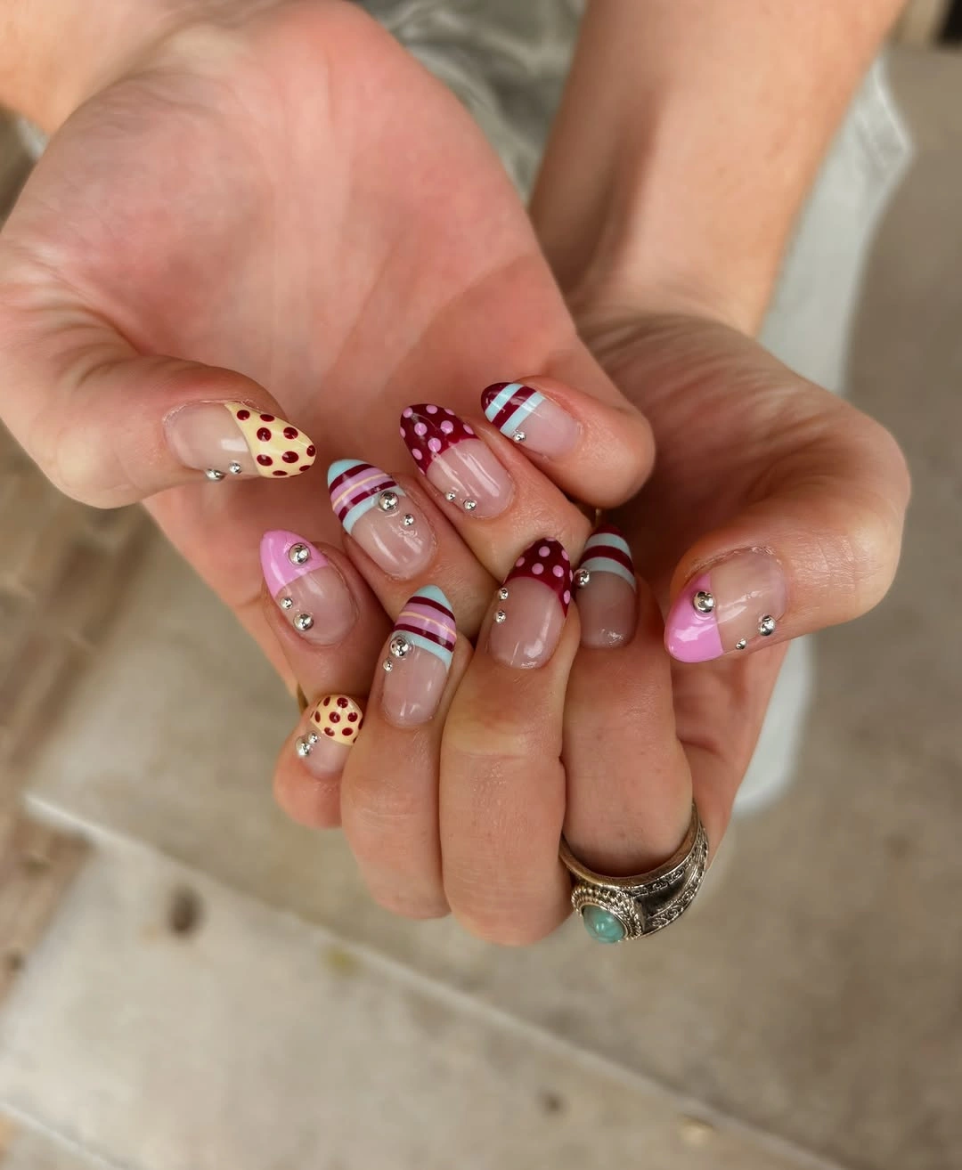 Short almond nails with colorful dots and stripes