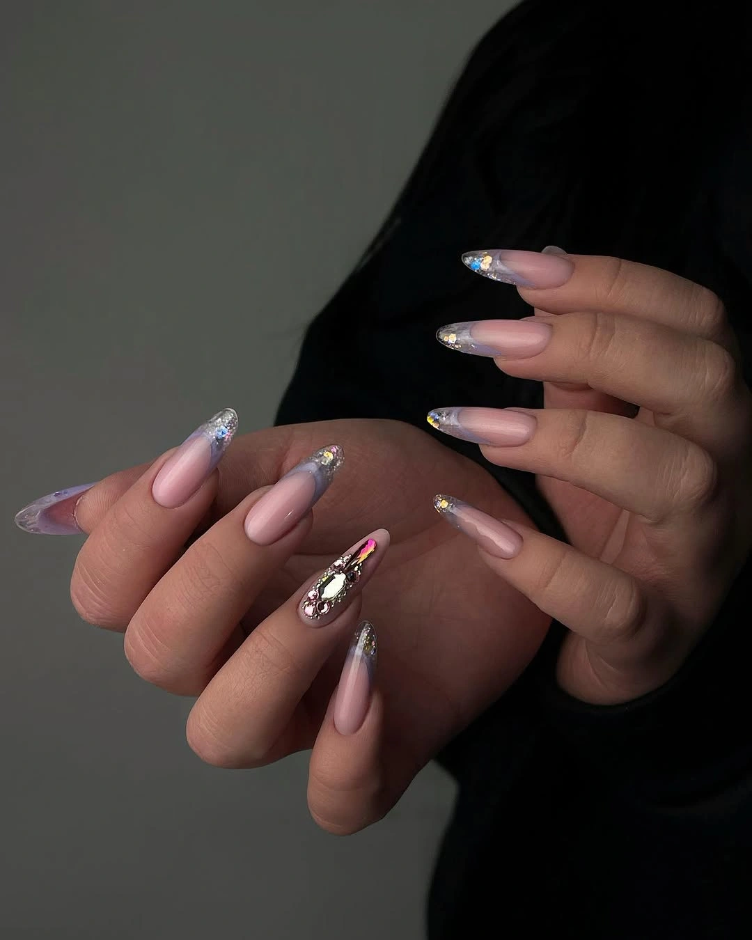 Clear glitter almond tips with one jeweled accent nail
