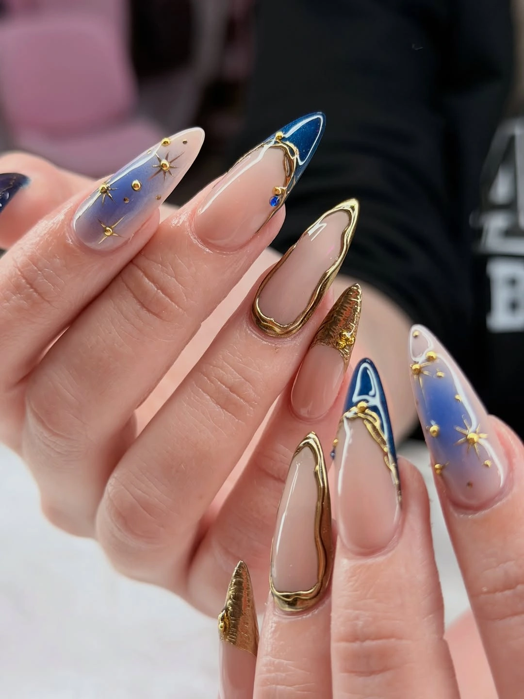 Navy almond tips with gold starburst accents