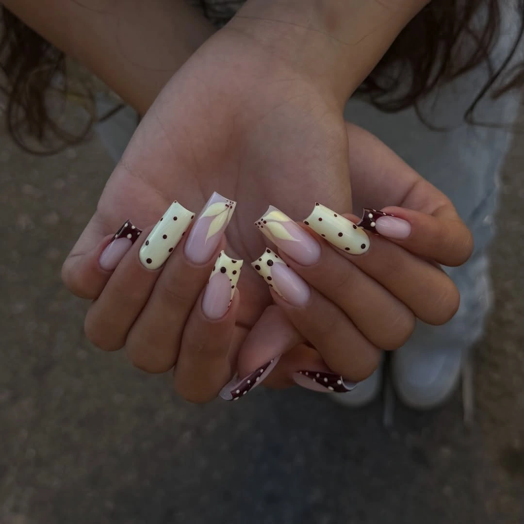 Brown polka-dot French tips with creamy yellow accents