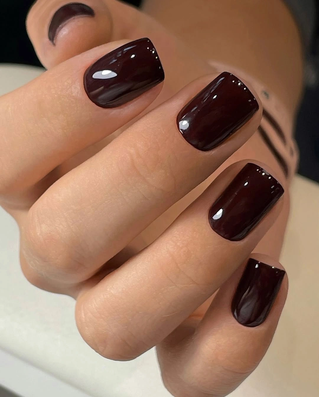 Short square nails in glossy dark chocolate burgundy