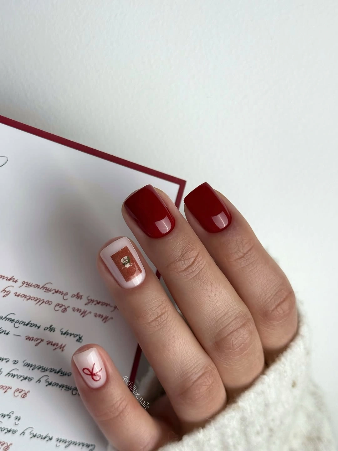 Short red square nails with small white geometric accents