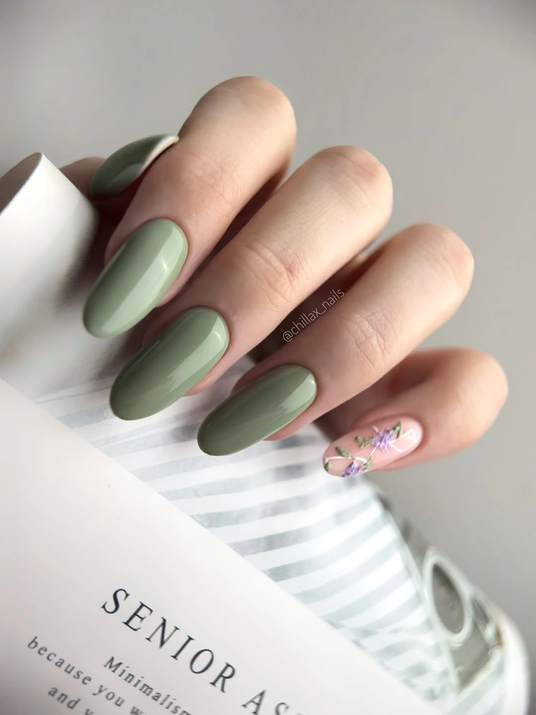 Medium sage almond nails with one small floral accent