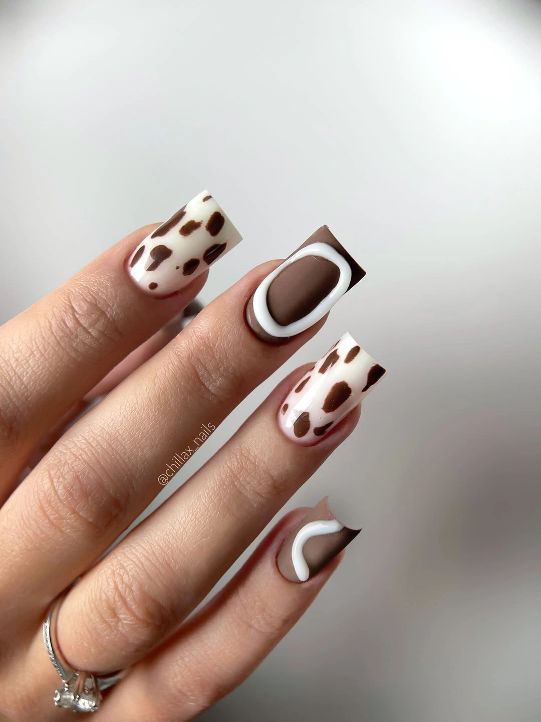 medium square nails with brown white curves and spotted accents