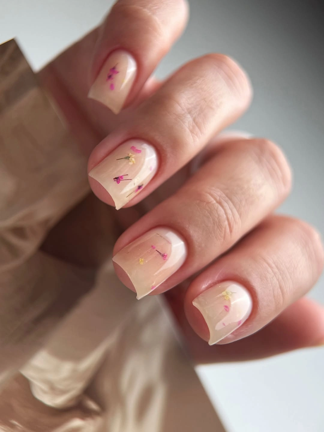 short blush square nails with tiny pink accent marks