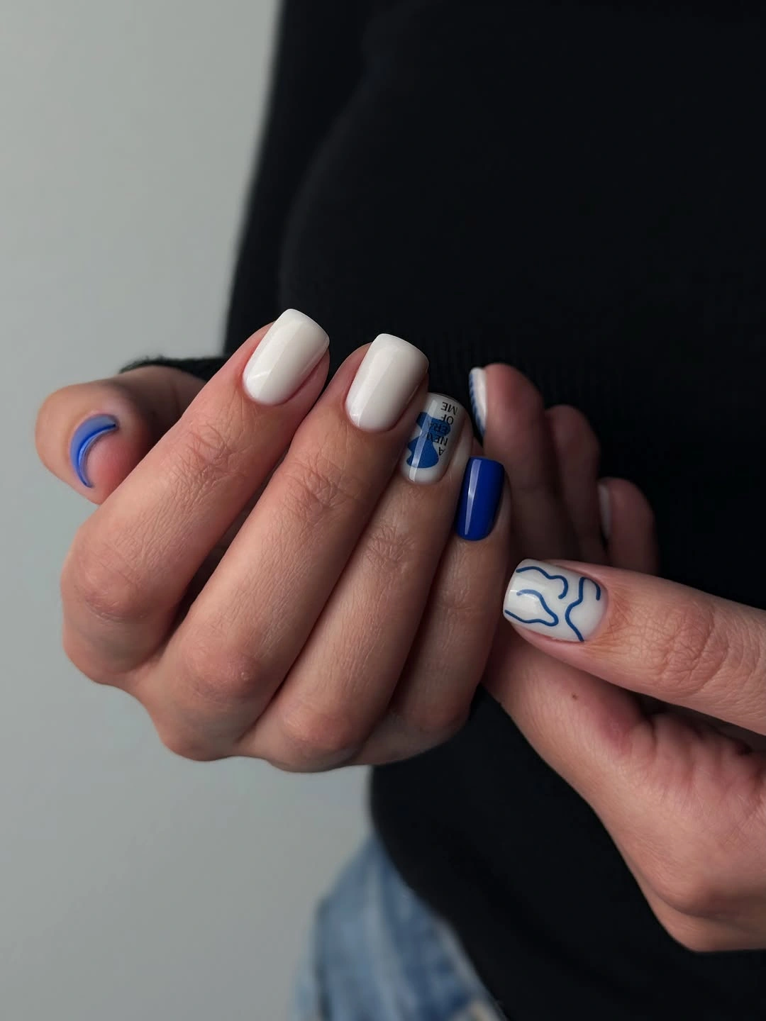 medium square nails with white bases and cobalt curves