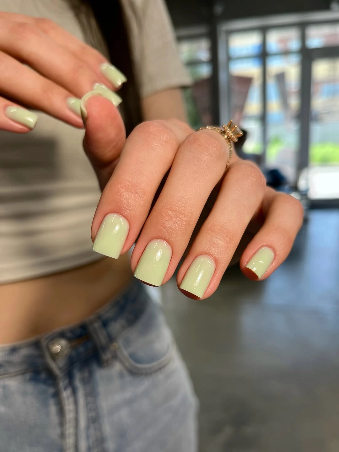 short square nails painted pale yellow green