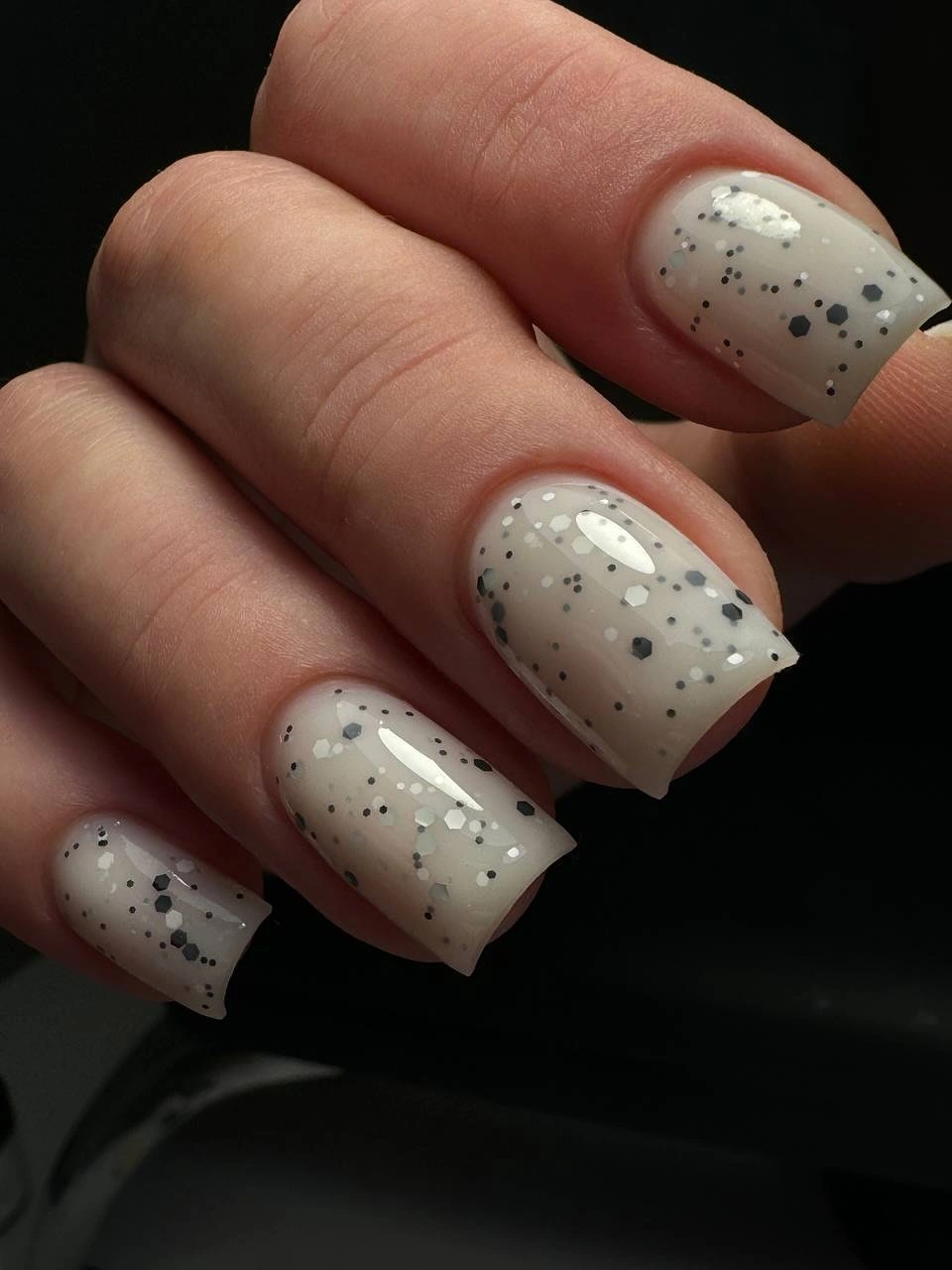 medium square nails with milky gray base and dark speckles