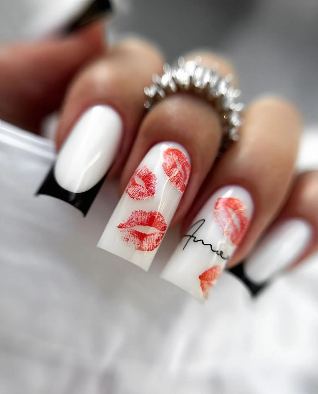 White French tip nails with red lip prints