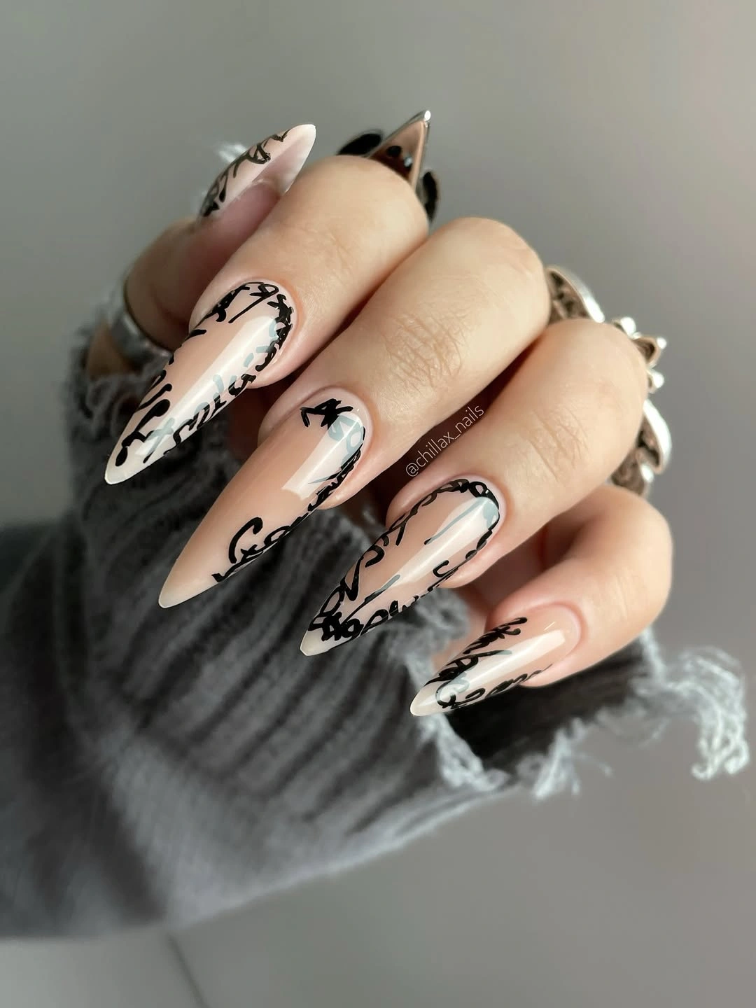 Long almond nails with black script lines