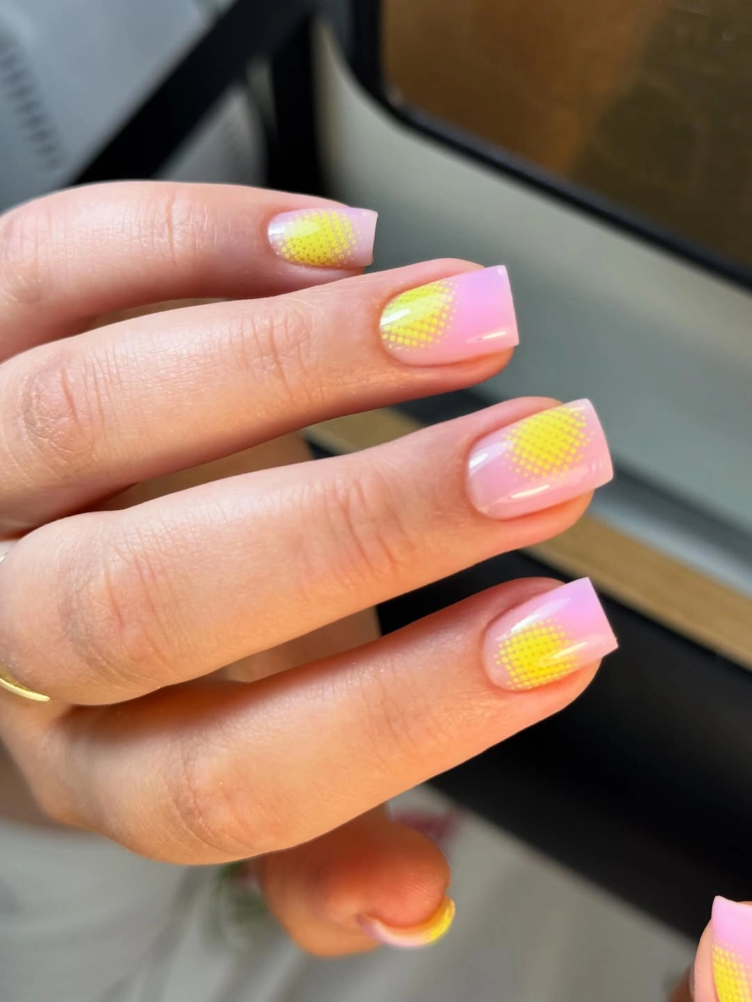 Pink square nails with yellow dot accents