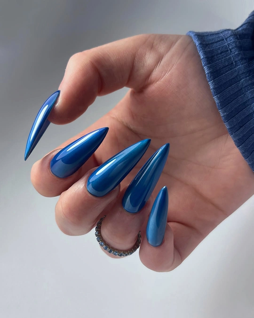 very long pointed nails in glossy electric cobalt blue