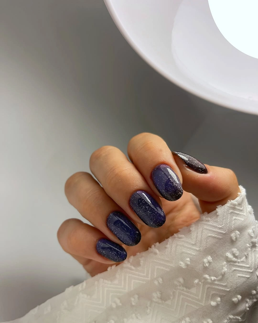 short square nails with deep navy violet sparkle