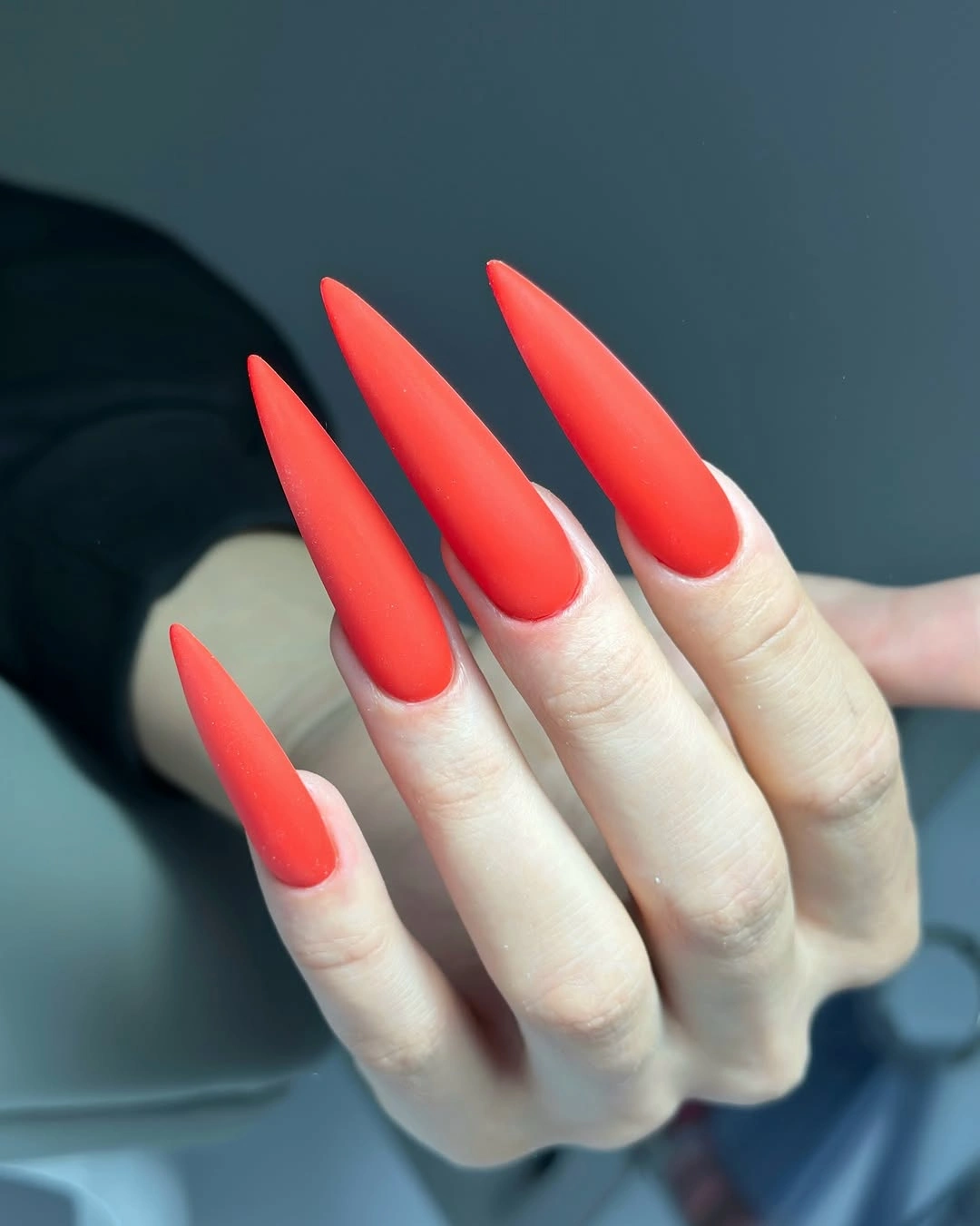 very long stiletto nails in vivid coral red