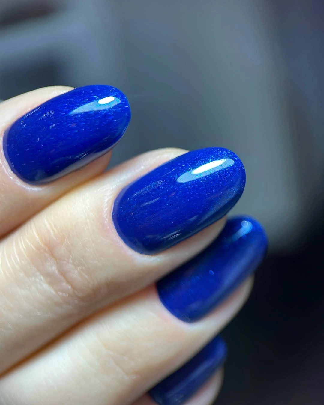 short oval nails painted glossy saturated cobalt blue