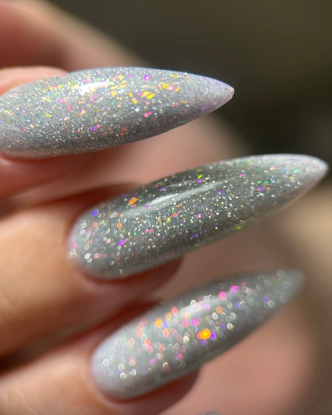 long almond nails with silver gray iridescent sparkle