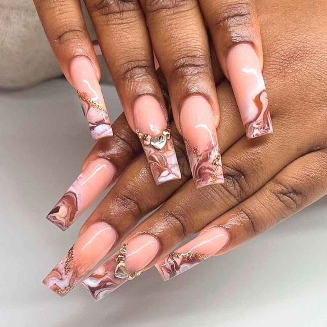 Long pink coffin nails with warm abstract tip accents