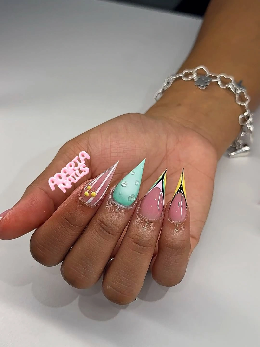 Long pointed nails with varied pastel and bright tip sections