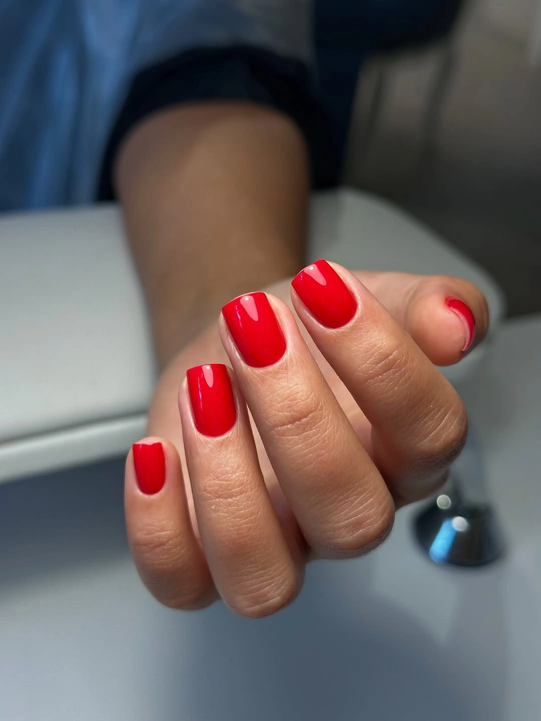 Short glossy cherry-red rounded-square nails with clean shine
