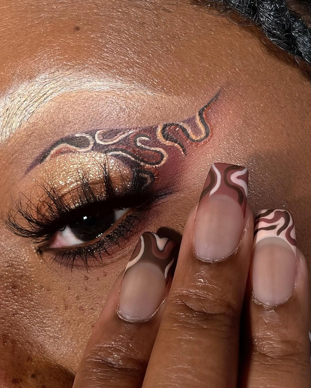 Nude nails with brown and white wavy line art
