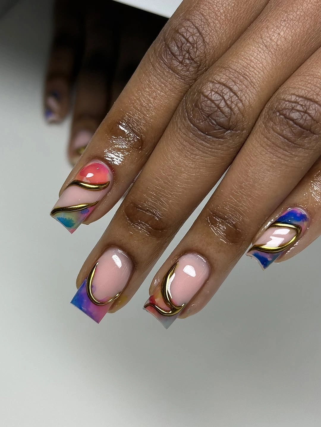 Pink square nails with metallic multicolor block tips