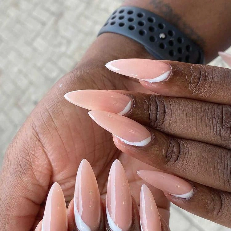 Long almond nude nails with diagonal white swoops