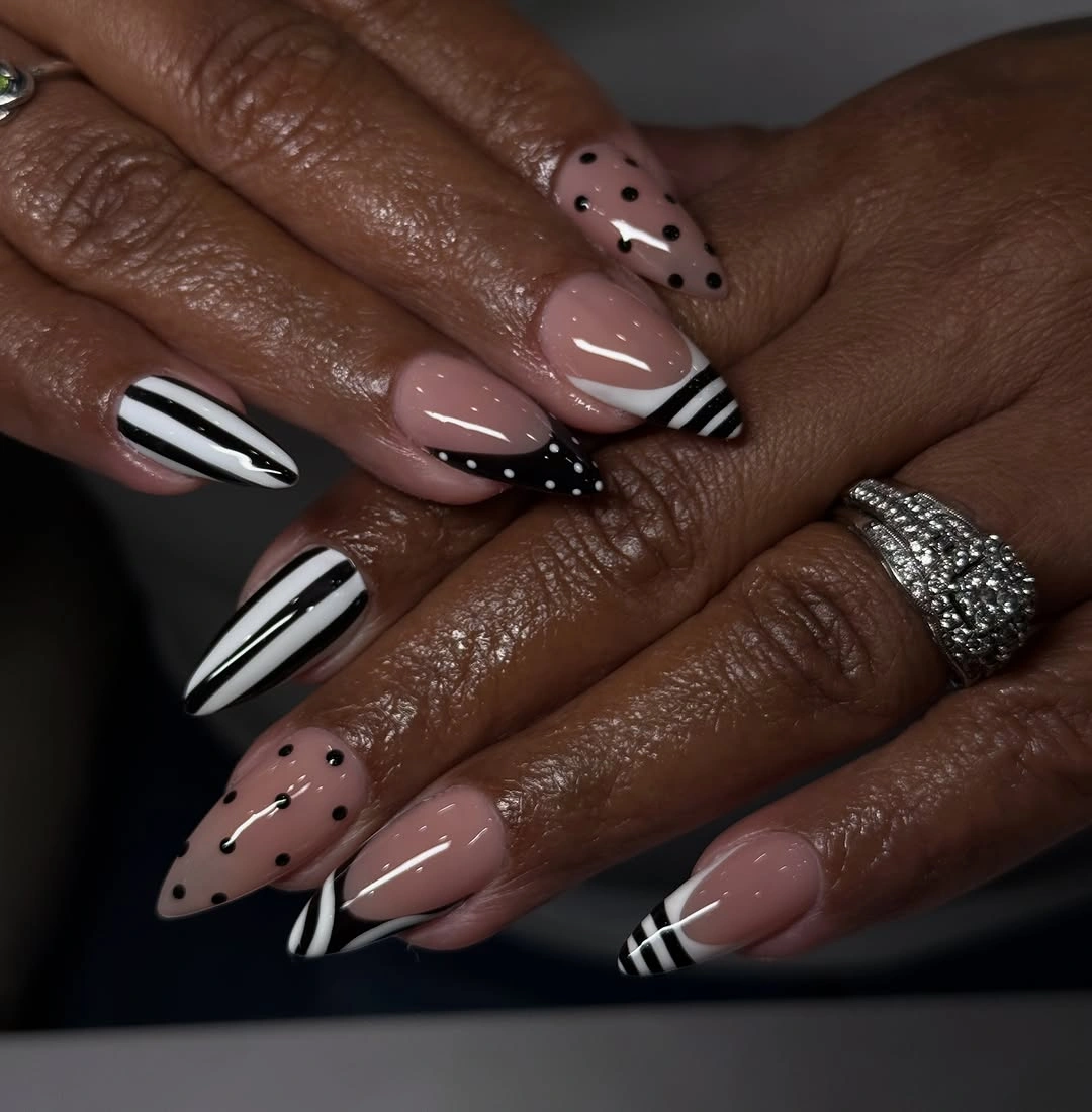 Black and white patterned almond nails on nude base
