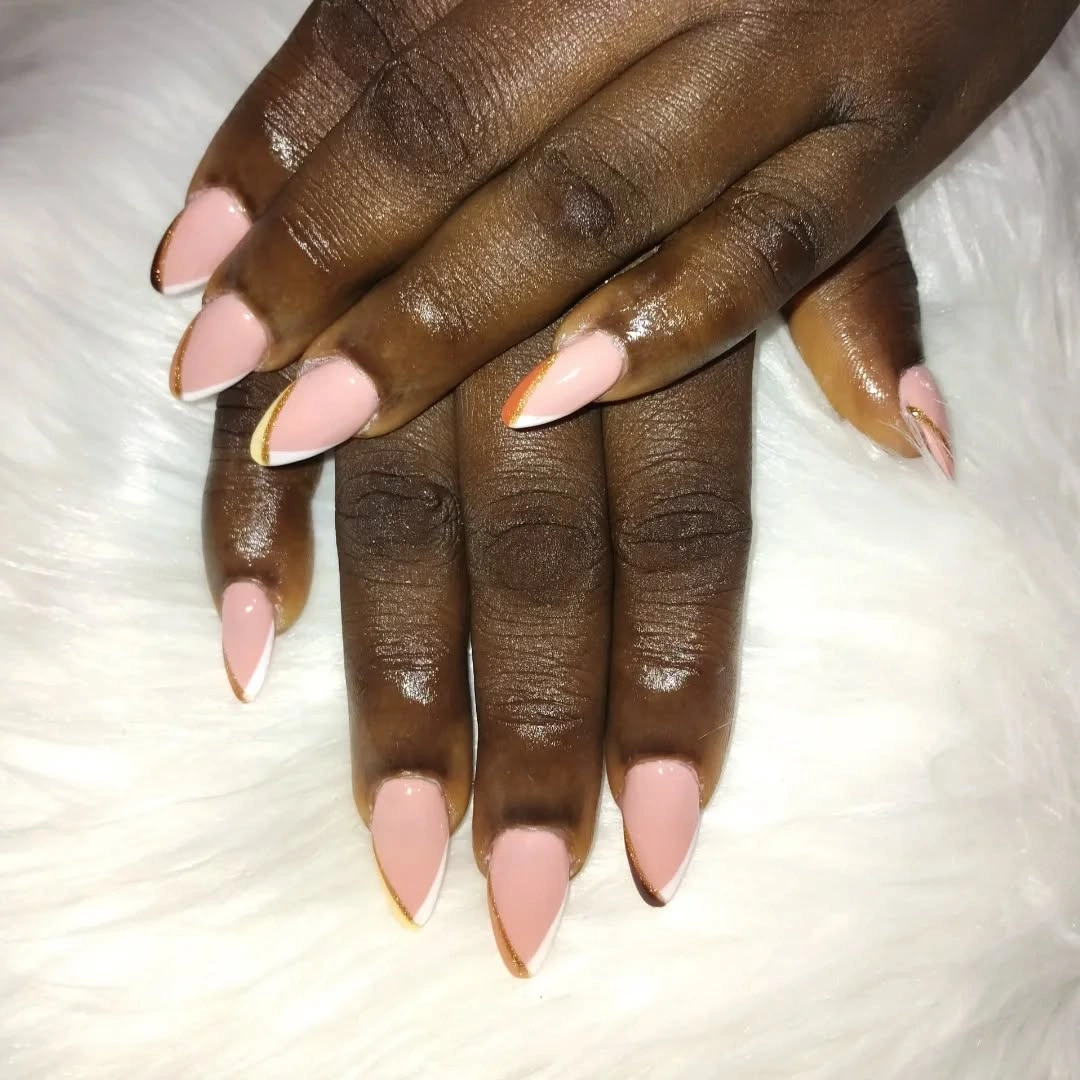 Soft almond nude nails with fine gold edges
