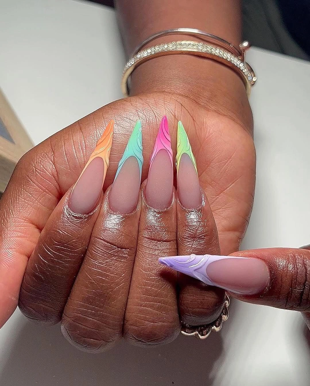Pastel stiletto French tips on muted nude nails