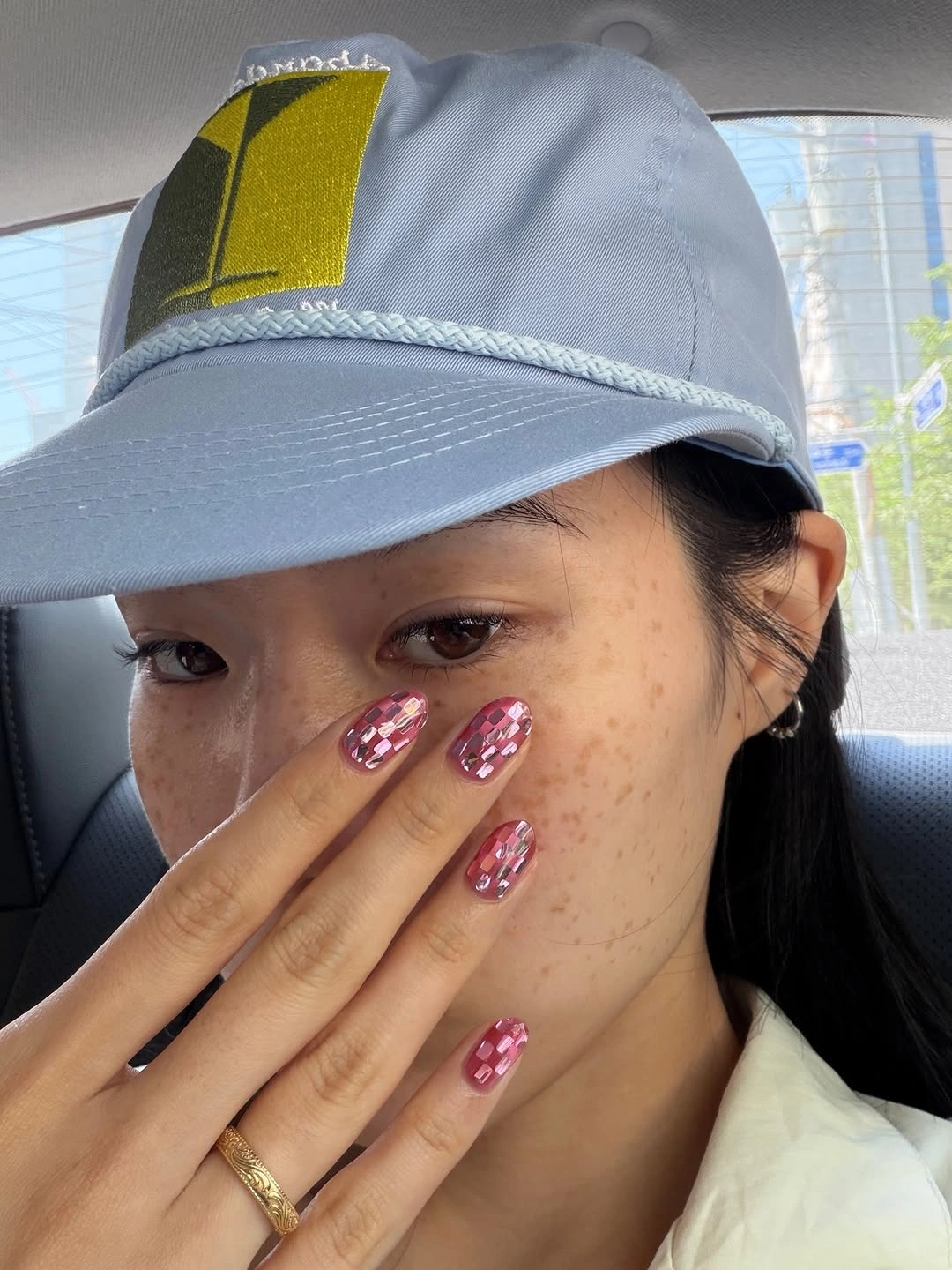 Short pink nails with tiny red white patterned accents