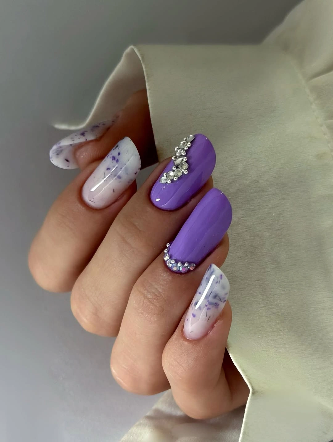 Muted purple square nails with white marbled accents