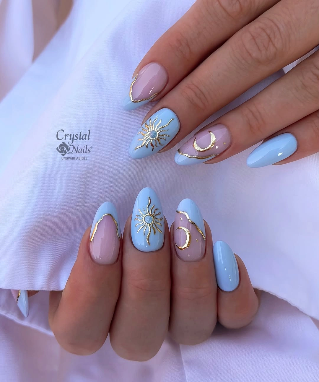 Pastel blue lavender nails with gold sun and crescent accents